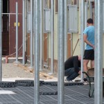 Verlegen der Bodenplatten um die Stützen des späteren Vordachs